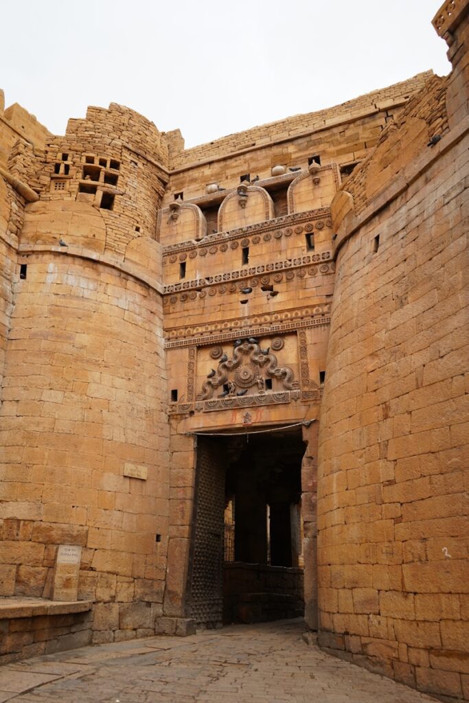 A stone building with a doorway and a clock on it