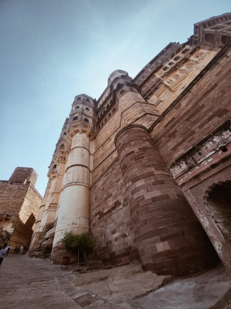 a very tall brick building with a clock on it's side